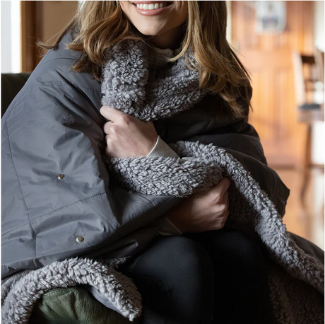 A woman was covered with a blanket outside to keep warm