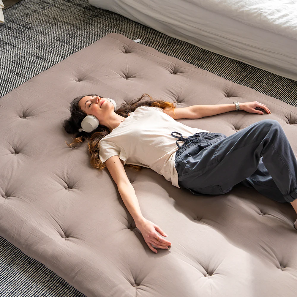 The woman relaxes on the futon mattress