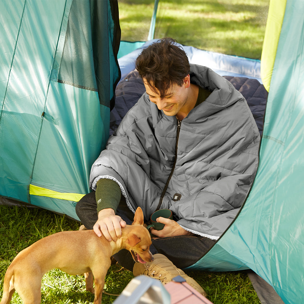 a man camping with a dog