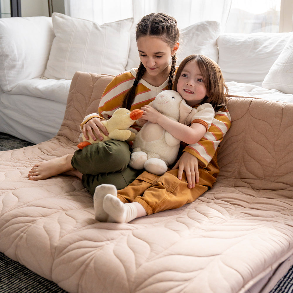 kids sit on a floor mattress