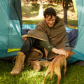 a man camping with a dog